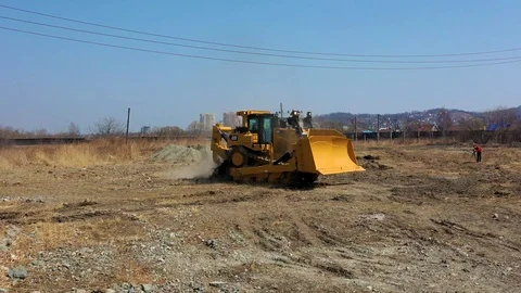 Bulldozer rides on the ground 2 Stock Footage 107378444