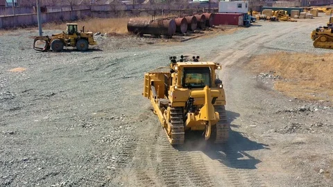 Bulldozer rides on the ground 4 Stock Footage 107378431