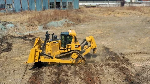Bulldozer rides on the ground Stock Footage 107378377