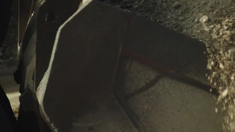 Bulldozer scoop loading stone pieces from pile, crushing machine, quarry work Video stock 294064992