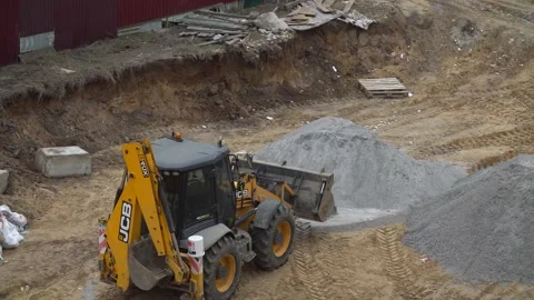 Bulldozer scoops up rubble with a bucket at a construction site. rubble mountain Stock Footage 154476241