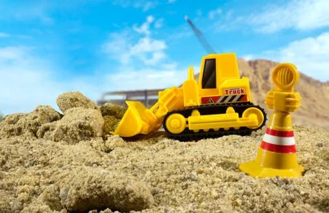 Bulldozer toy side view with warning sign. Foto stock