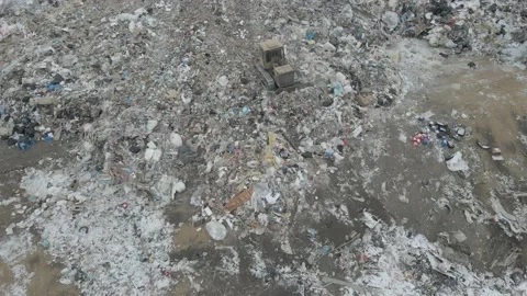 Bulldozer tractor pushes garbage from a mountain in a city dump Stock-Footage 147400401