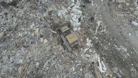 Bulldozer tractor pushes garbage from a mountain in a city dump Stock-Footage 147400421