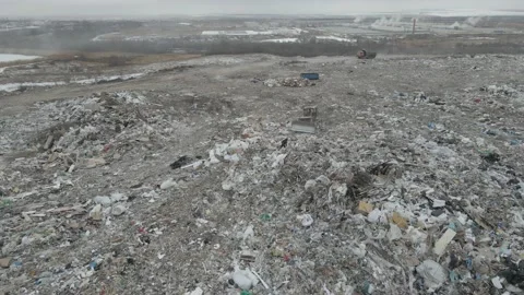 Bulldozer tractor pushes garbage from a mountain in a city dump Stock-Footage 147400463
