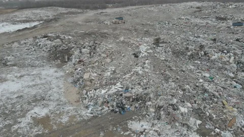 Bulldozer tractor pushes garbage from a mountain in a city dump Stock-Footage 147400747