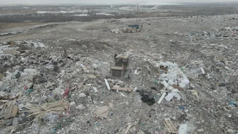 Bulldozer tractor pushes garbage from a mountain in a city dump Stock-Footage 147400768