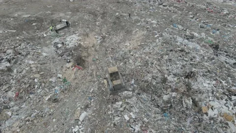 Bulldozer tractor pushes garbage from a mountain in a city dump Stock-Footage 147400788