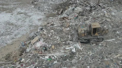 Bulldozer tractor pushes garbage from a mountain in a city dump Stock-Footage 147400807