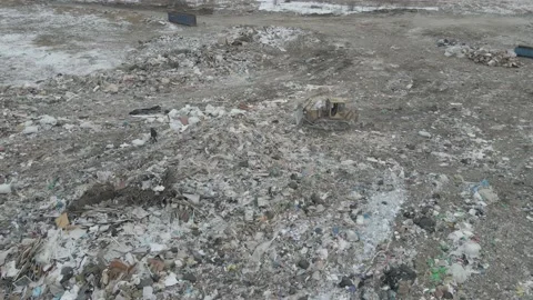 Bulldozer tractor pushes garbage from a mountain in a city dump Stock-Footage 148656672