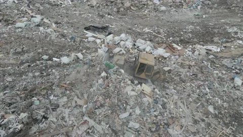 Bulldozer tractor pushes garbage from a mountain in a city dump Stock-Footage 148656830