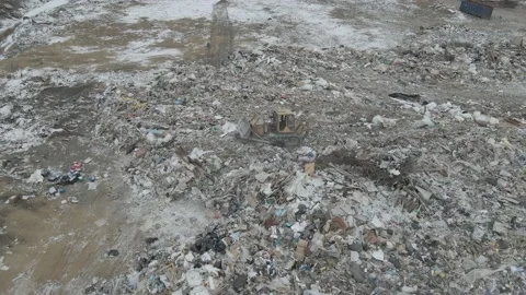 Bulldozer tractor pushes garbage from a mountain in a city dump Stock-Footage 148657409
