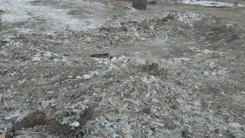 Bulldozer tractor pushes garbage from a mountain in a city dump Stock-Footage 148658094