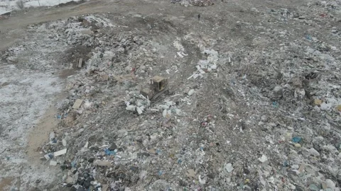 Bulldozer tractor pushes garbage from a mountain in a city dump Stock-Footage 148658410