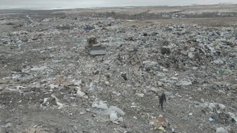 Bulldozer tractor pushes garbage from a mountain in a city dump 스톡 동영상 170595625