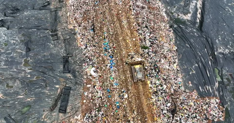 Bulldozer trolleys working in garbage dumps, Large Urban Waste Treatment Plant Stock Footage 168503717