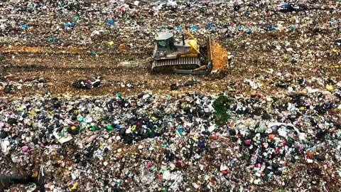 Bulldozer trolleys working in garbage dumps, cleaning up garbage   Stock Footage 168504055