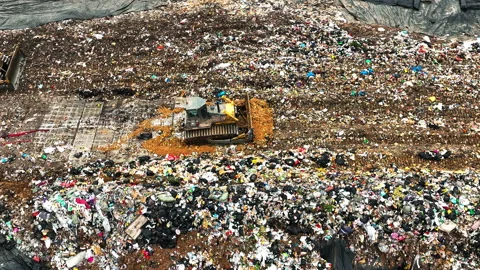 Bulldozer trolleys working in garbage dumps, Large Urban Waste Treatment Plant Stock Footage 168504187
