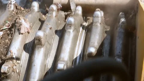 Bulldozer working at the dump. Close-up studded metal wheel Stockbeeldmateriaal 76200587
