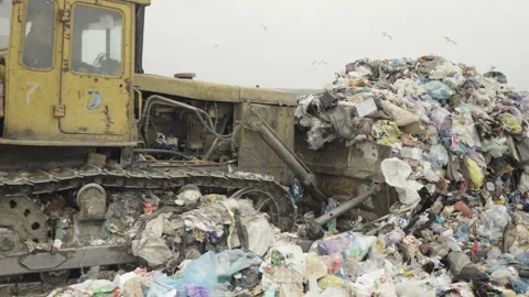 A bulldozer working at a landfill Stock Footage 306789708