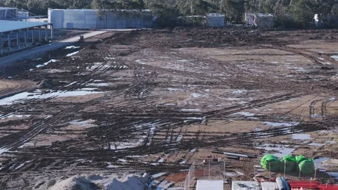 Bulldozer working on a large muddy construction site Stock Footage 341259163