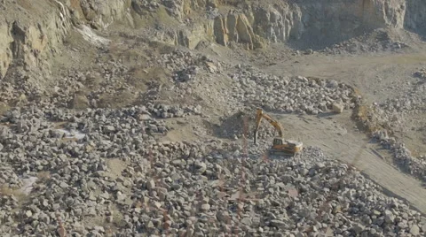 Bulldozer working at mining site loading stone on a truck Stock Footage 47499092