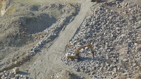 Bulldozer working at mining site loading stone on a truck Stock Footage 47499102