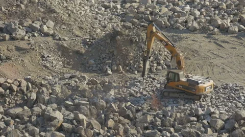 Bulldozer working at mining site loading stone on a truck Stock Footage 47499125