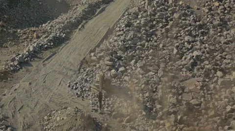 Bulldozer working at mining site loading stone on a truck Stock Footage 47499335