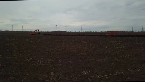 Bulldozers digging ground with buckets at the start of construction Drone shot Stock Footage 120734227