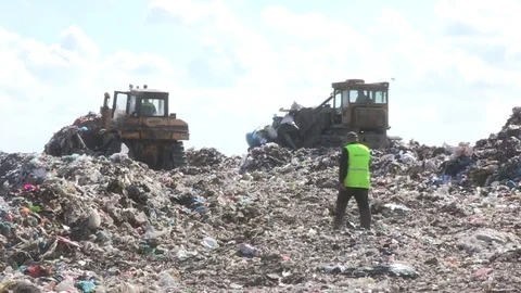 Bulldozers moving trash at garbage dump. Stock Footage 71379139