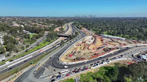 Bulleen interchange construction with Melbourne skyline in the distance Stock Footage 282087147