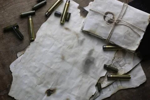 Bullet and retro paper on the table concept of global crime machine cartri... Stock Photos