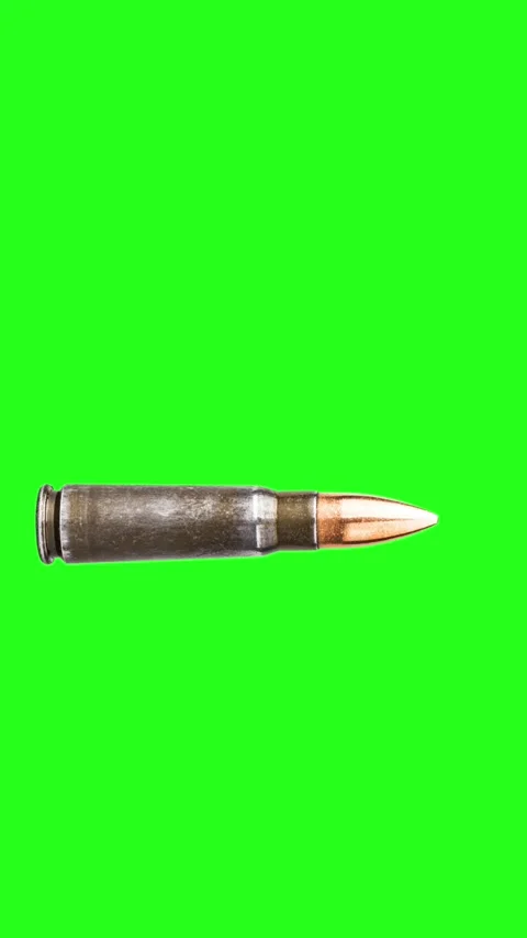 Bullet with case flying on green screen background Stock Footage 325690299