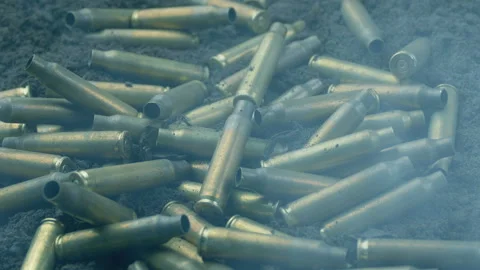 Bullet Cases Hit The Ground With Muzzle Flashes And Smoke Stock Footage 160846203