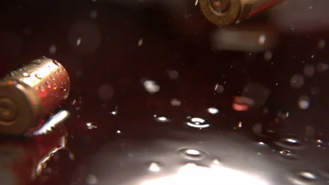 Bullet Casing Falling Into Blood At Crime Scene. Red Blood on Ground In Rain Stock Footage