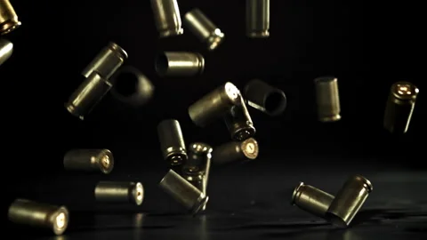 Bullet casings are pressed on the table. Filmed on a high-speed camera at 1000 Stock Footage 319316574