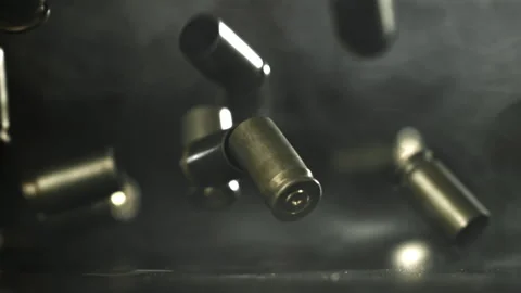 Bullet casings are pressed on the table. Filmed on a high-speed camera at 1000 Stock Footage 319318298