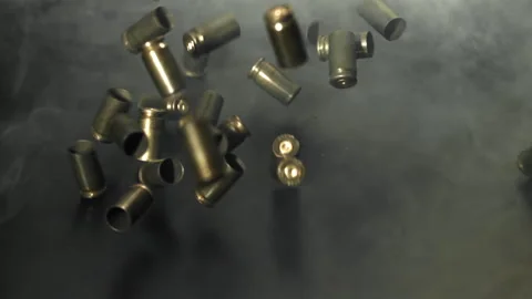 Bullet casings are pressed on the table. Filmed on a high-speed camera at 1000 Stock Footage 319322212