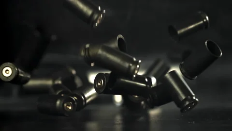 Bullet casings are pressed on the table. Filmed on a high-speed camera at 1000 Stock Footage 319323016