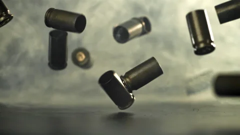 Bullet casings are pressed on the table. Filmed on a high-speed camera at 1000 Stock Footage 319323299