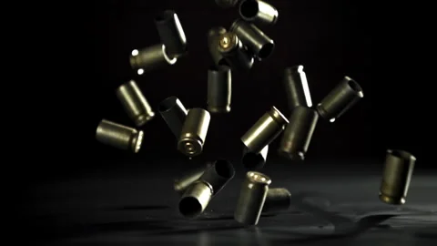 Bullet casings are pressed on the table. Filmed on a high-speed camera at 1000 Stock Footage 319324494