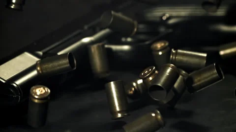 Bullet casings are pressed on the table. Filmed on a high-speed camera at 1000 Stock Footage 319329653
