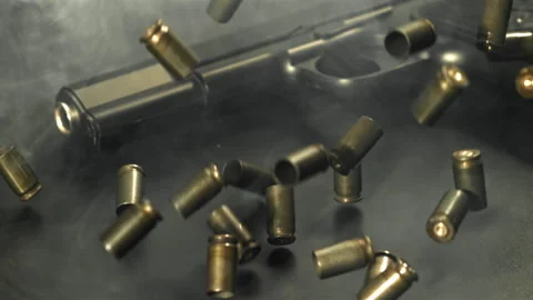 Bullet casings are pressed on the table. Filmed on a high-speed camera at 1000 Stock Footage 319331271