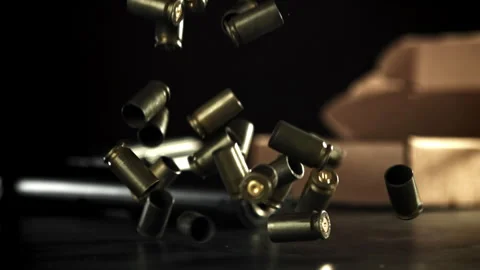 Bullet casings are pressed on the table. Filmed on a high-speed camera at 1000 Stock Footage 319333832
