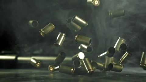 Bullet casings are pressed on the table. Filmed on a high-speed camera at 1000 Stock Footage 319343642