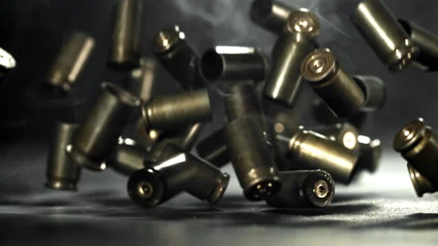 Bullet casings are pressed on the table. Filmed on a high-speed camera at 1000 Stock Footage 319344909