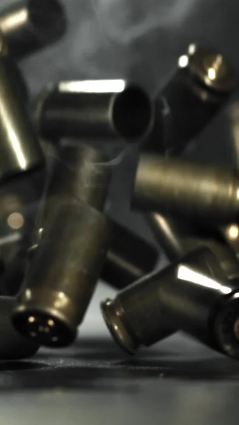 Bullet casings are pressed on the table. Filmed on a high-speed camera at 1000 Stock Footage 335363679