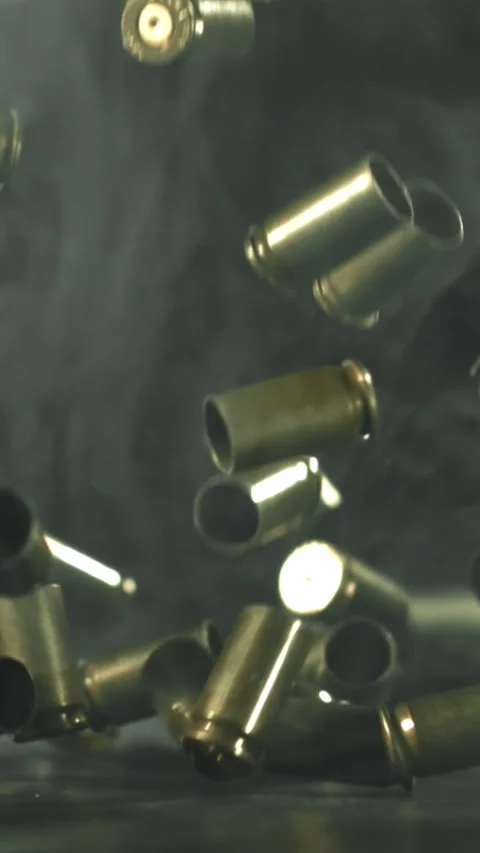 Bullet casings are pressed on the table. Filmed on a high-speed camera at 1000 Stock Footage 335363748
