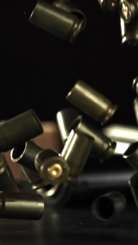 Bullet casings are pressed on the table. Filmed on a high-speed camera at 1000 Stock Footage 335365943